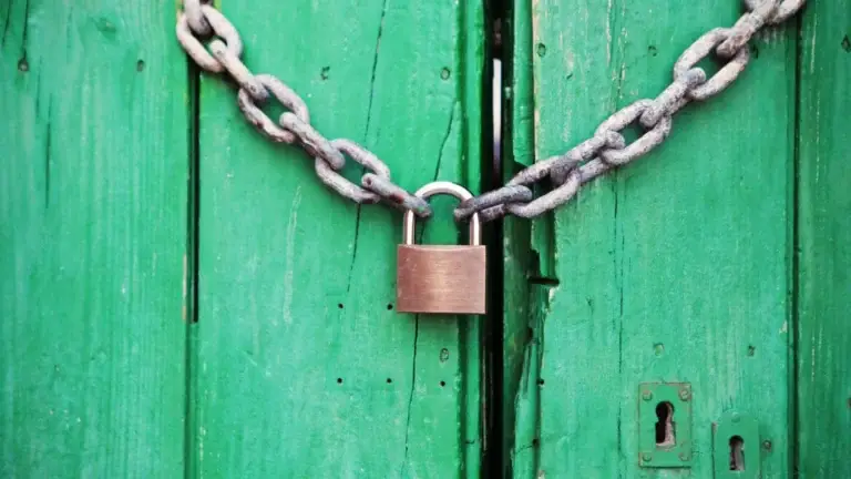 Image of a lock on a green wood door