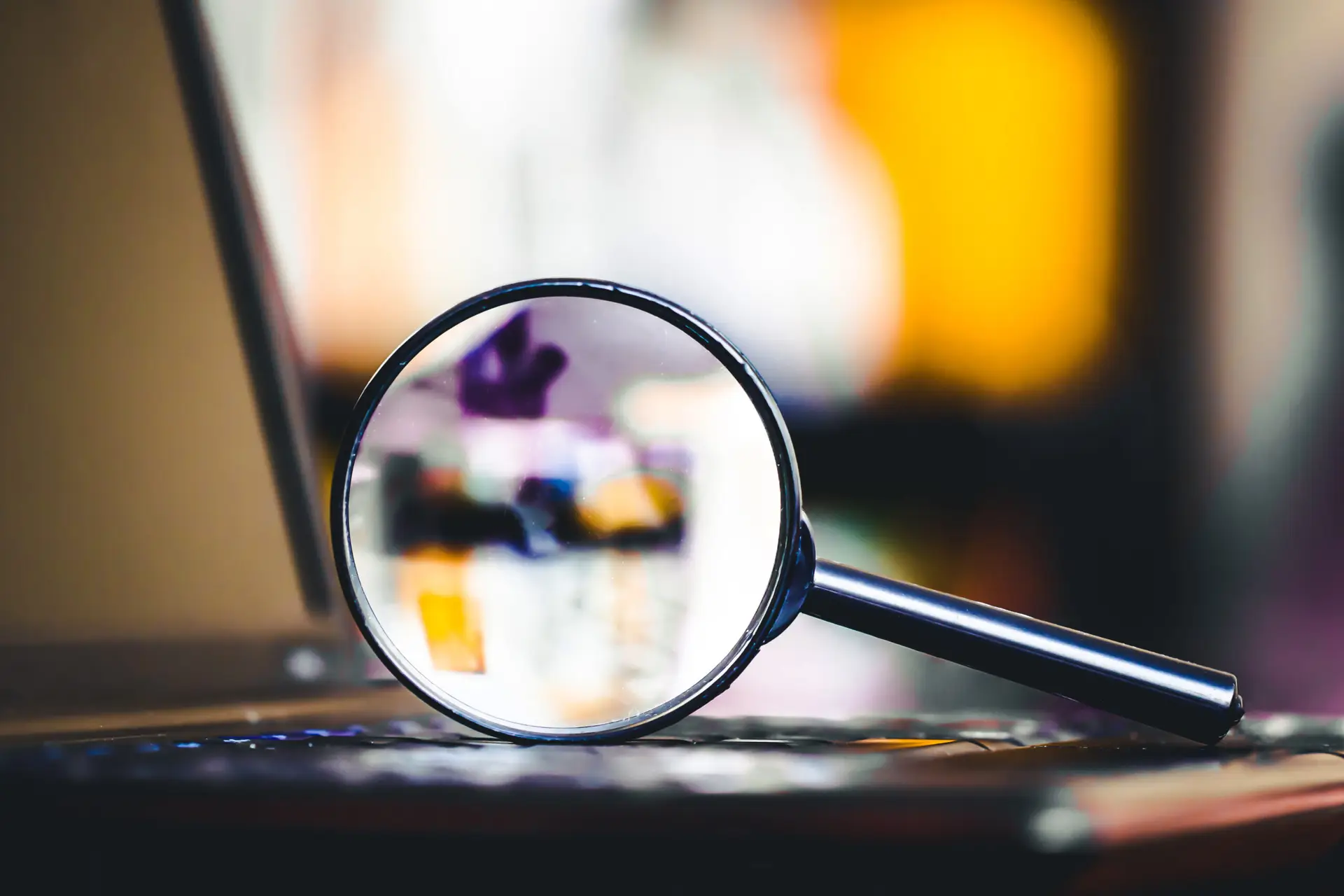 Magnifying glass on laptop keyboard