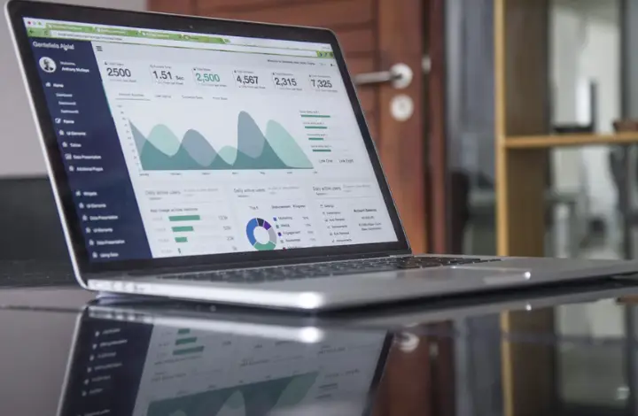 An Image of a open laptop displaying a graph with numbers