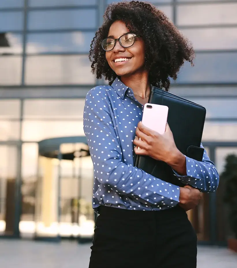 woman carrying her portfolio and smiling