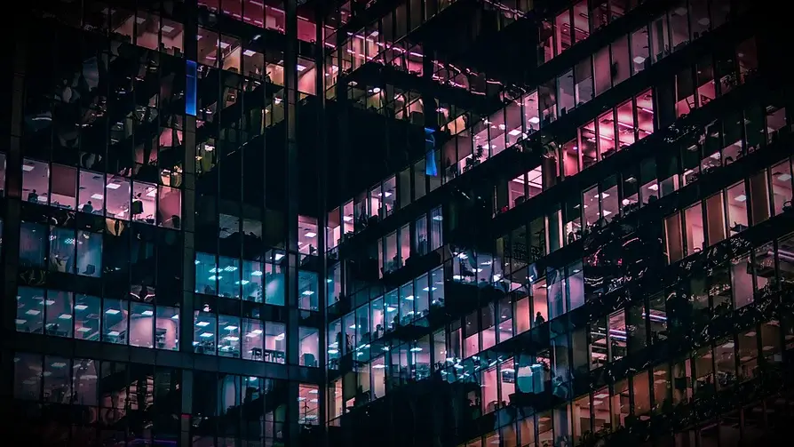 Image taken from the outside of a glass office during nighttime