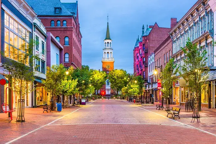 image of a clock tower as viewed from down the well lit, empty street.