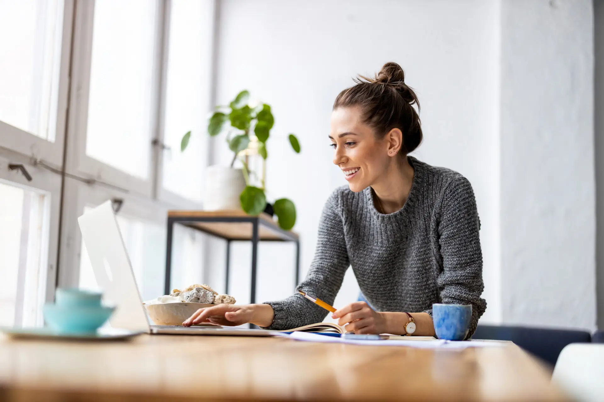 Woman smiling and looking at laptop