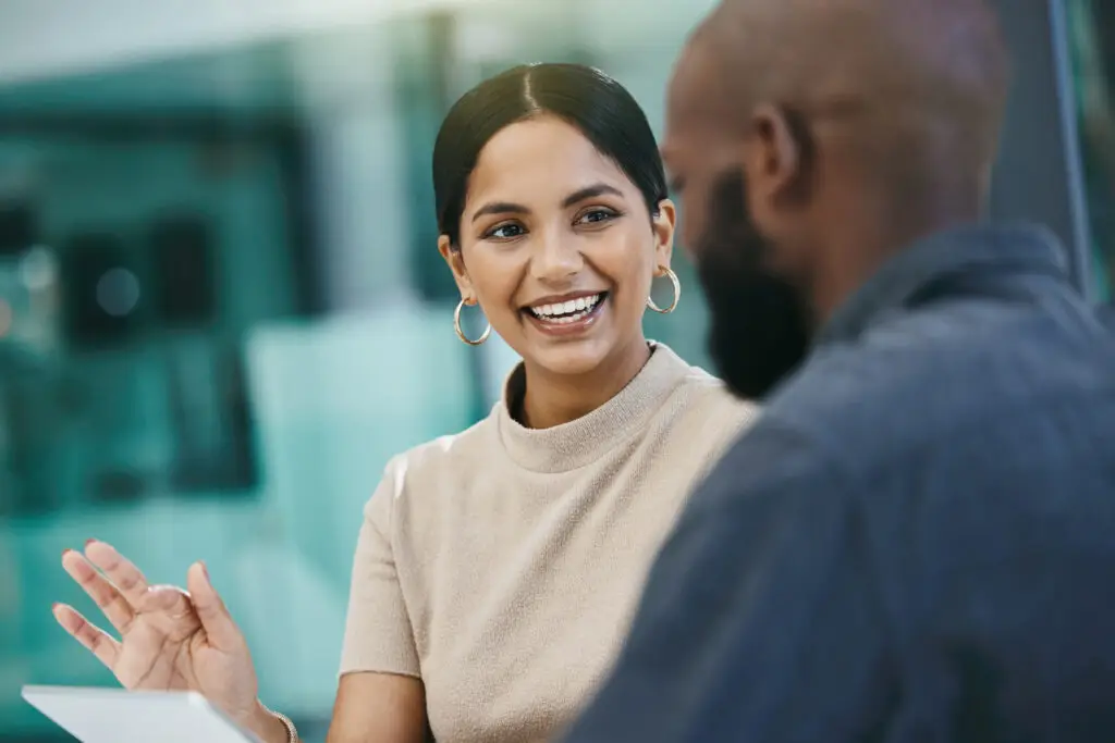 Professional woman having conversation with colleague