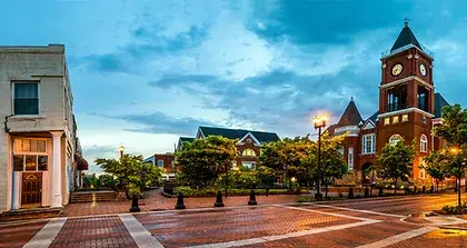 SylogistGov | image of a small downtown, with no people around at night time