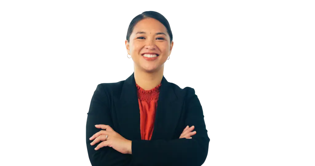 Woman with freckles in business attire with arms crossed